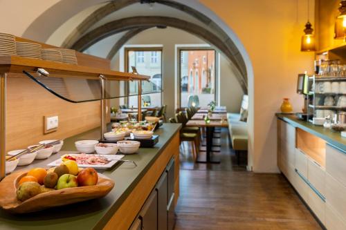 a kitchen with a buffet of food on a counter at Altstadthotel Arch in Regensburg