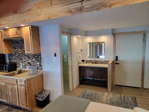 a kitchen with wooden cabinets and a counter top at Silver Ridge Lodge in Salida