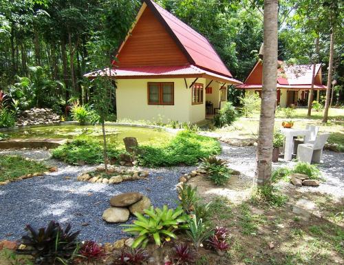 a small house with a garden in front of it at Manora Garden in Phangnga