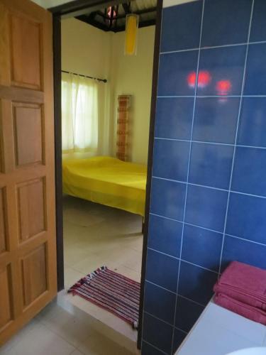a mirror in front of a room with a bed at Manora Garden in Phangnga