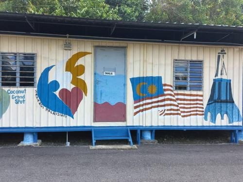 a building with paintings on the side of it at Tmn Rekreasi Cikgu Haron in Labis