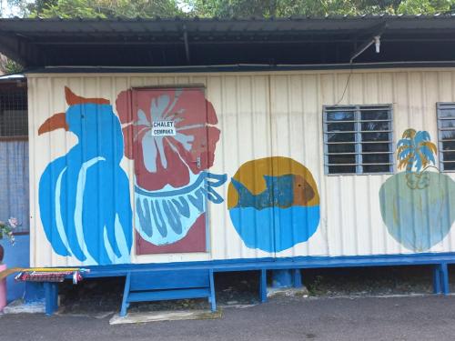 a building with paintings on the side of it at Tmn Rekreasi Cikgu Haron in Labis