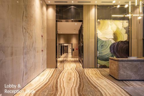 a hallway in a building with a painting on the wall at Son&Henry The MarQ Luxury in Ho Chi Minh City