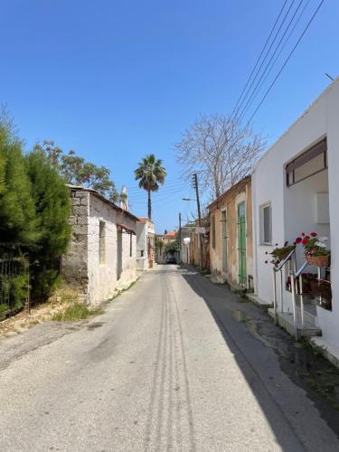 an empty street in a small town with a palm tree at Betul Guest House in Famagusta