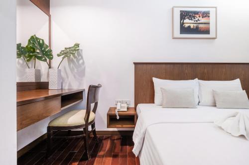 a bedroom with a bed and a desk and a chair at P2 Boutique in Bangkok