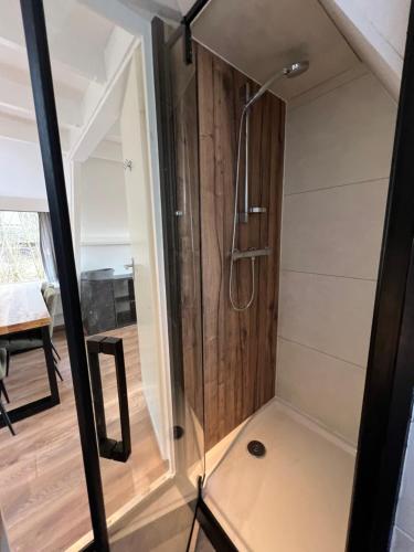 a bathroom with a shower with a glass door at Bos Chalet Durbuy in Durbuy