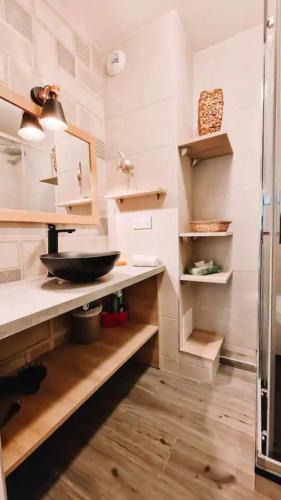 eine Küche mit einem Waschbecken und Holzregalen in der Unterkunft T3 refait à neuf /Plage/Centre/Gare/Terrasse/Pkg/wifi in Arcachon