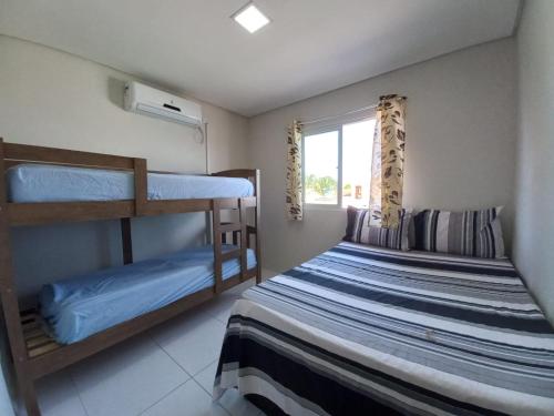 1 dormitorio con 2 literas y ventana en Aconchego em Maragogi, en Maragogi