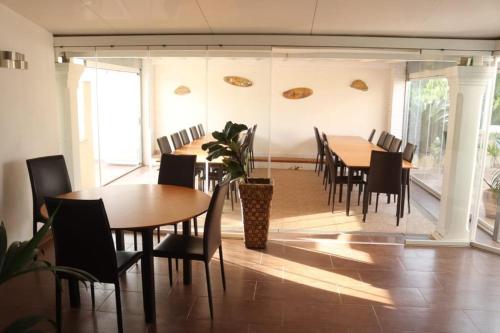 a dining room with wooden tables and chairs at Casa Raíces del Montgo in Denia