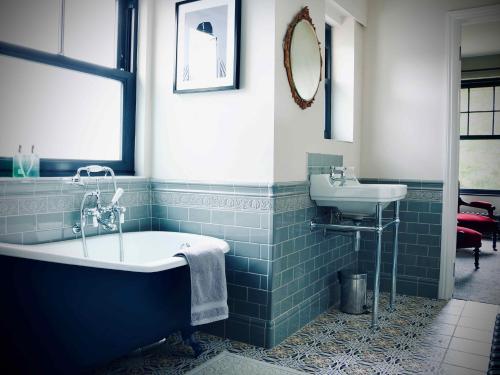 a bathroom with a tub and a sink at Suie Hunting Lodge in Killin