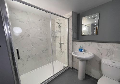 a bathroom with a shower and a toilet and a sink at Flat on Poole Quay near Sandbanks in Poole