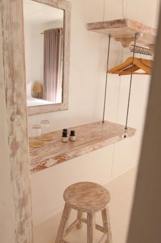 a wooden stool and a mirror in a room at Lagon energy dakhla in Dakhla