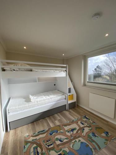 a bedroom with a bed and a window and a rug at Ferienwohnung Ostseetraum in Damp
