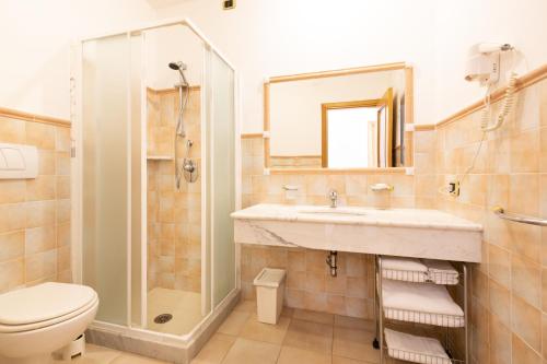 a bathroom with a sink and a shower and a toilet at Riviera Residence in Marina di Pietrasanta