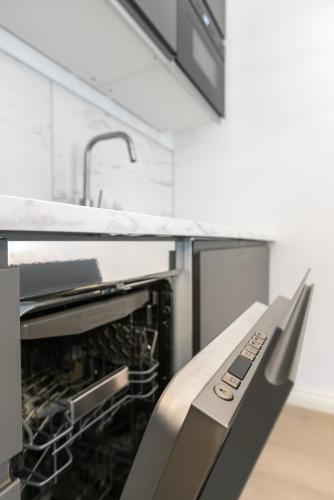 a kitchen with an oven and a sink at Flygeln in Leksand
