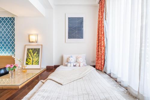 a living room with a bed and a window at P2 Boutique in Bangkok