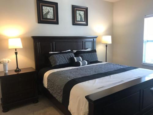 a bedroom with a large bed with two lamps at 3 Bedrooms 2 Bathrooms Lucaya Village 22-103 in Orlando