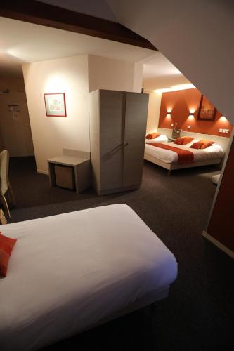 a hotel room with two beds and a cabinet at Logis Le Bourguignon in Bèze