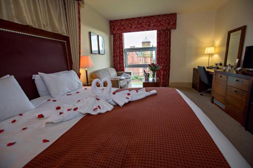 a hotel room with a bed with roses on it at Holiday Inn Dumfries by IHG in Dumfries