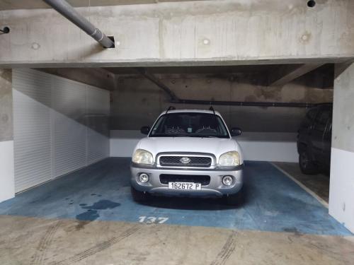 a small car parked in a parking garage at Elégant F3 à la Villa Stencer, Papeete, calme climatisé et spacieux in Papeete