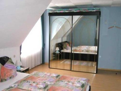 a bedroom with two beds and a glass wall at Ferienwohnung Lioba Kunst in Amorbach