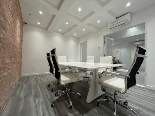 a conference room with a white table and chairs at Hotel and the City, Empire State Building in New York