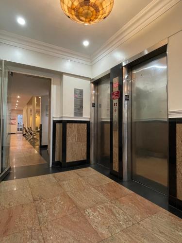 a hallway with elevators in a building at Hotel and the City, Empire State Building in New York