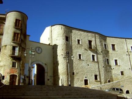 a large stone building with a clock on it at Al Campanaro b&b in Taurasi