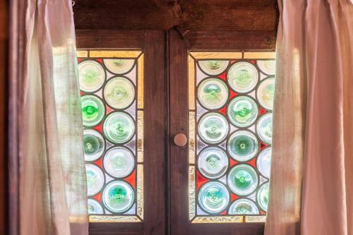 a door with a stained glass window with a curtain at Stoffelhäusl in Reith im Alpbachtal