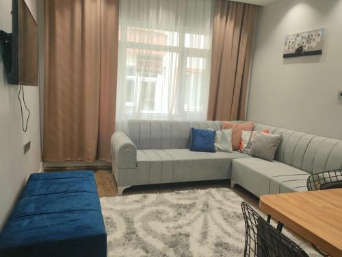 a living room with a couch and a table at Tekin Suit in Bandırma