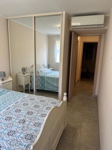 a bedroom with a bed and a mirror at Appartement T3 centre ville in Bastia