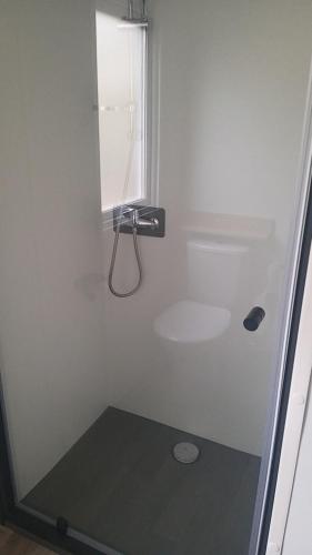 a bathroom with a shower with a sink at Amira 6 personnes in Saint-Jean-de-Monts