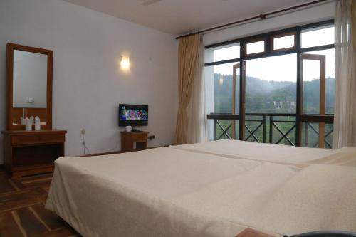 a bedroom with a bed and a large window at Alta Vista in Ella