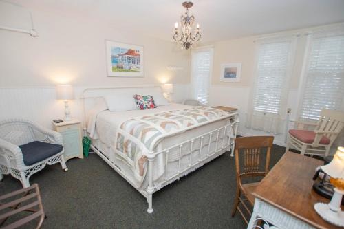 a bedroom with a bed and a table and chairs at Terrace Inn and 1911 Restaurant in Petoskey