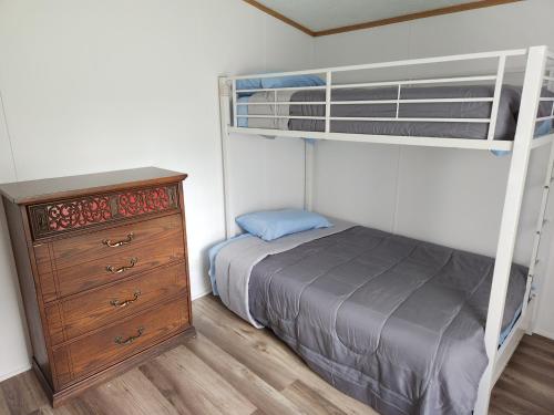 a bedroom with a bunk bed and a dresser at Sharon's Run Cozy 3 bedroom/2 bath 