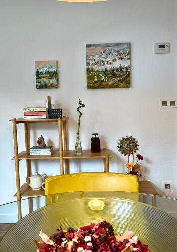 a table with a plate of food on a yellow chair at Angliru 1 Suite in Santa Eulalia de Morcín