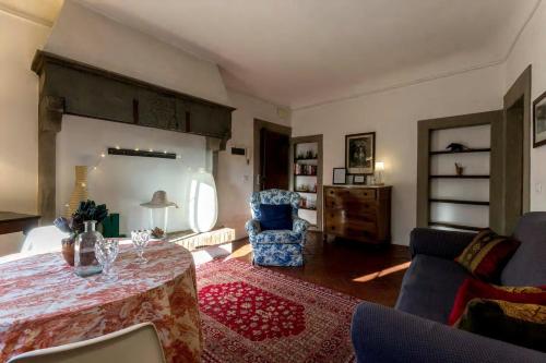 a living room with a table and a chair at Residenza dei Medici Palace Niccolò in Florence