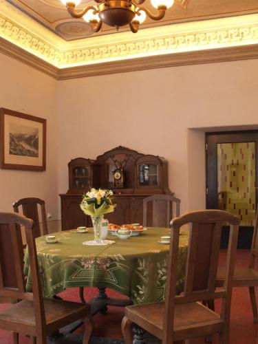 a dining room table with a vase of flowers on it at Ekocentrum DOTEK in Horní Maršov