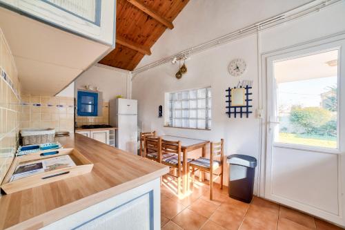 Il comprend une cuisine et une salle à manger avec une table. dans l'établissement Maison avec jardin à 200m de la plage La Cantine, à La Guérinière