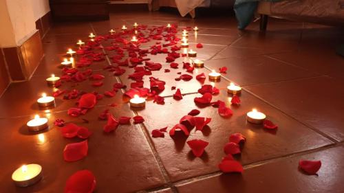 a group of red hearts and candles on the floor at Hostal Dulces Sueños in Panajachel