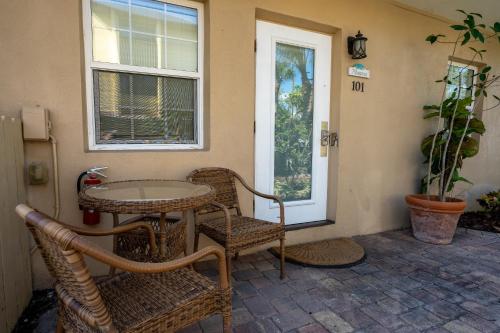 a patio with a table and chairs and a window at The Capri at Siesta in Siesta Key