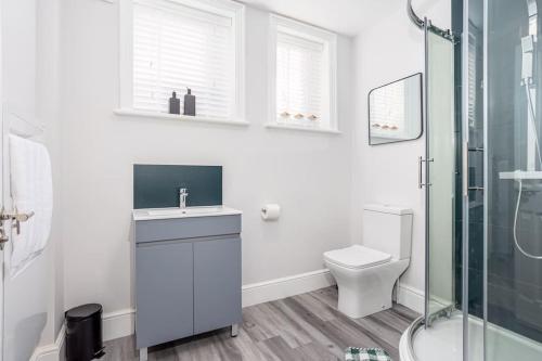 a white bathroom with a shower and a toilet at Coppergate Mews Grimsby No.5 - 1 bed, 1 bath, 1st floor apartment in Grimsby