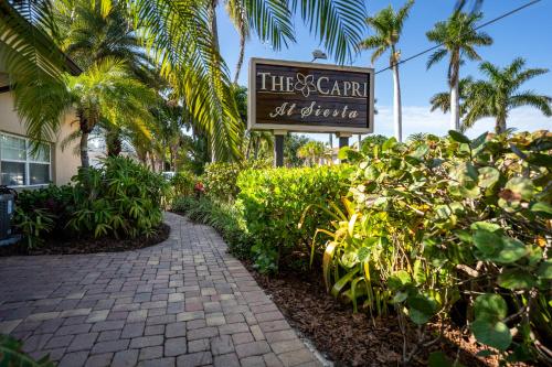 a sign for a hotel with a walkway at The Capri at Siesta in Siesta Key
