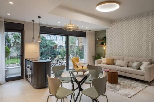 a living room with a table and chairs and a couch at Talbiye brand new luxury place in Jerusalem