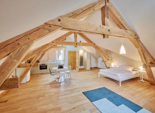 a large room with a bed and a table at Dépendance de Sibra in Lagarde