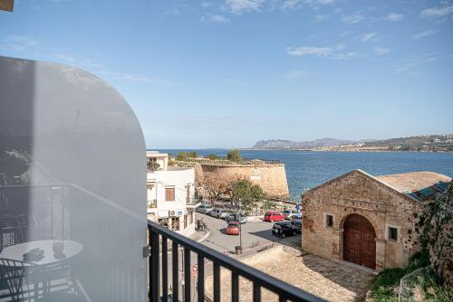 a balcony with a view of a street and the water at Ethos Suites in Chania Town