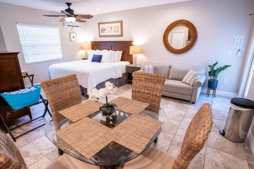a living room with a bed and a table and chairs at The Capri at Siesta in Siesta Key