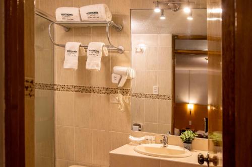 a bathroom with a sink and a mirror at Casona Plaza Balsa Inn in Puno