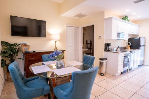 a kitchen and dining room with a table and chairs at The Capri at Siesta in Siesta Key