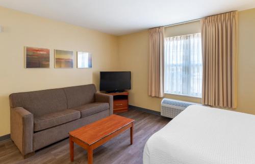 a living room with a couch and a tv at Extended Stay America Suites - Norfolk - Virginia Beach in Virginia Beach